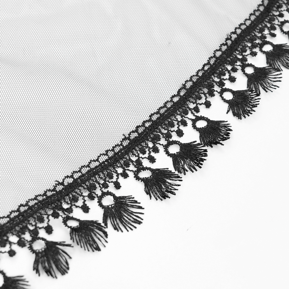 Close-up of elegant black lace with fringed detailing on tulle fabric for gothic fashion and accessories.