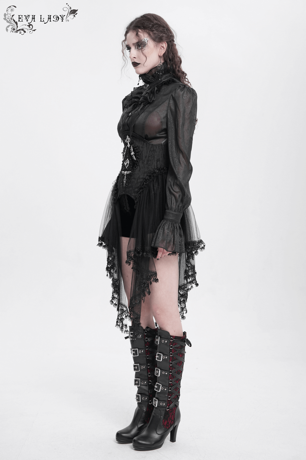 Model in Gothic underbust corset with lace overlay and tulle, styled with knee-high boots and dramatic makeup.