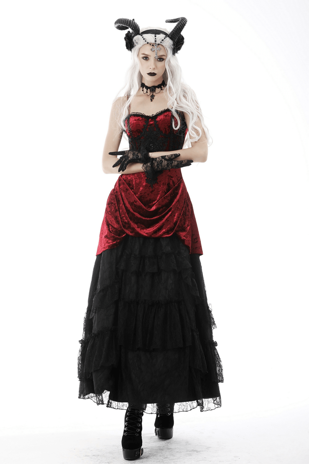 Gothic model in red corset and black layered maxi skirt, showcasing a dark fantasy style with striking horns and makeup.