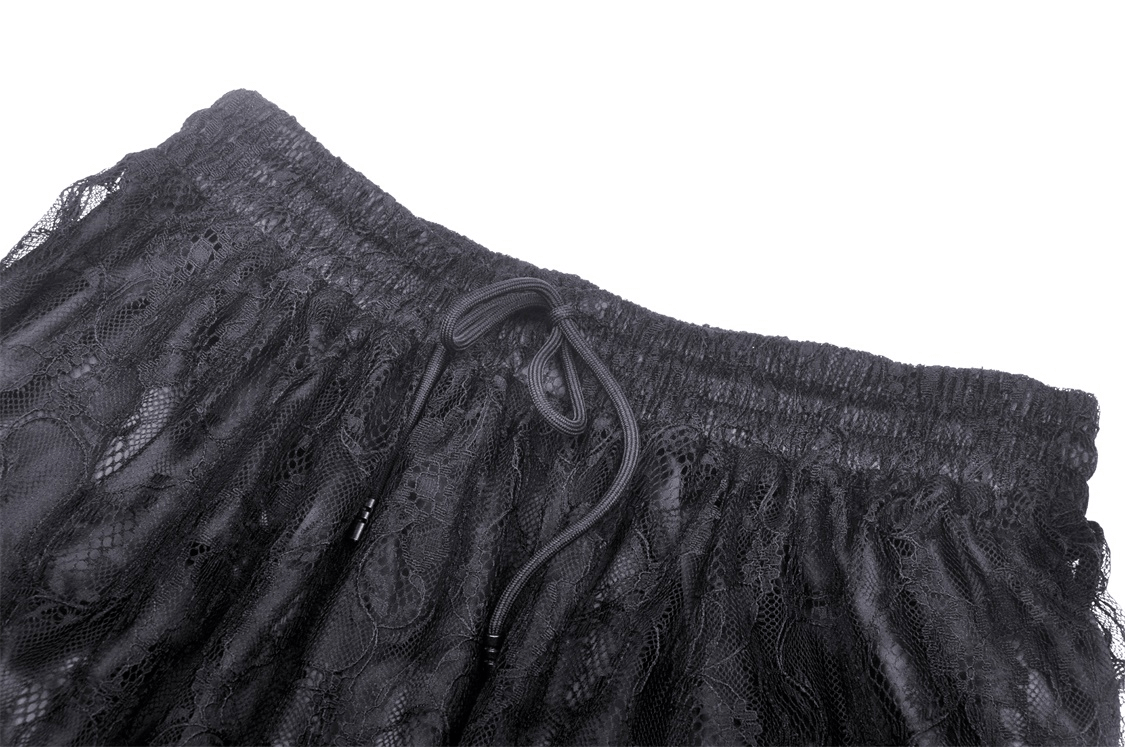 Close-up of the high-waisted waistband of a black lace maxi skirt featuring drawstring detail and delicate floral design.