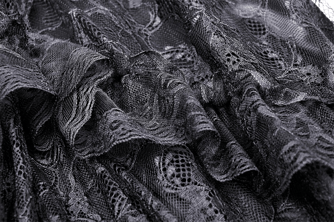 Close-up of elegant black lace fabric with intricate patterns, perfect for a gothic-style maxi skirt.