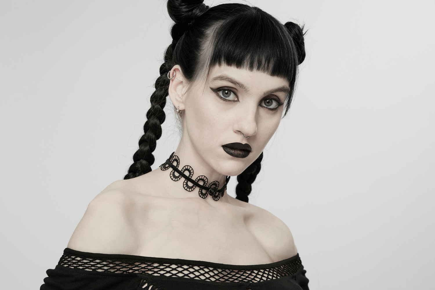 Gothic model showcasing a dark floral snake lace choker necklace with a bold look and striking makeup.