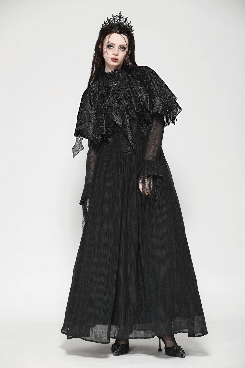 Elegant woman in a dark goth fringed cape with lace details, embodying Victorian charm and gothic style.