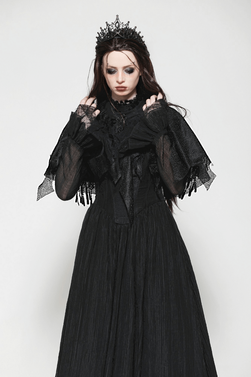 Dark Goth fringed cape with lace details worn by a woman in a dramatic black outfit.