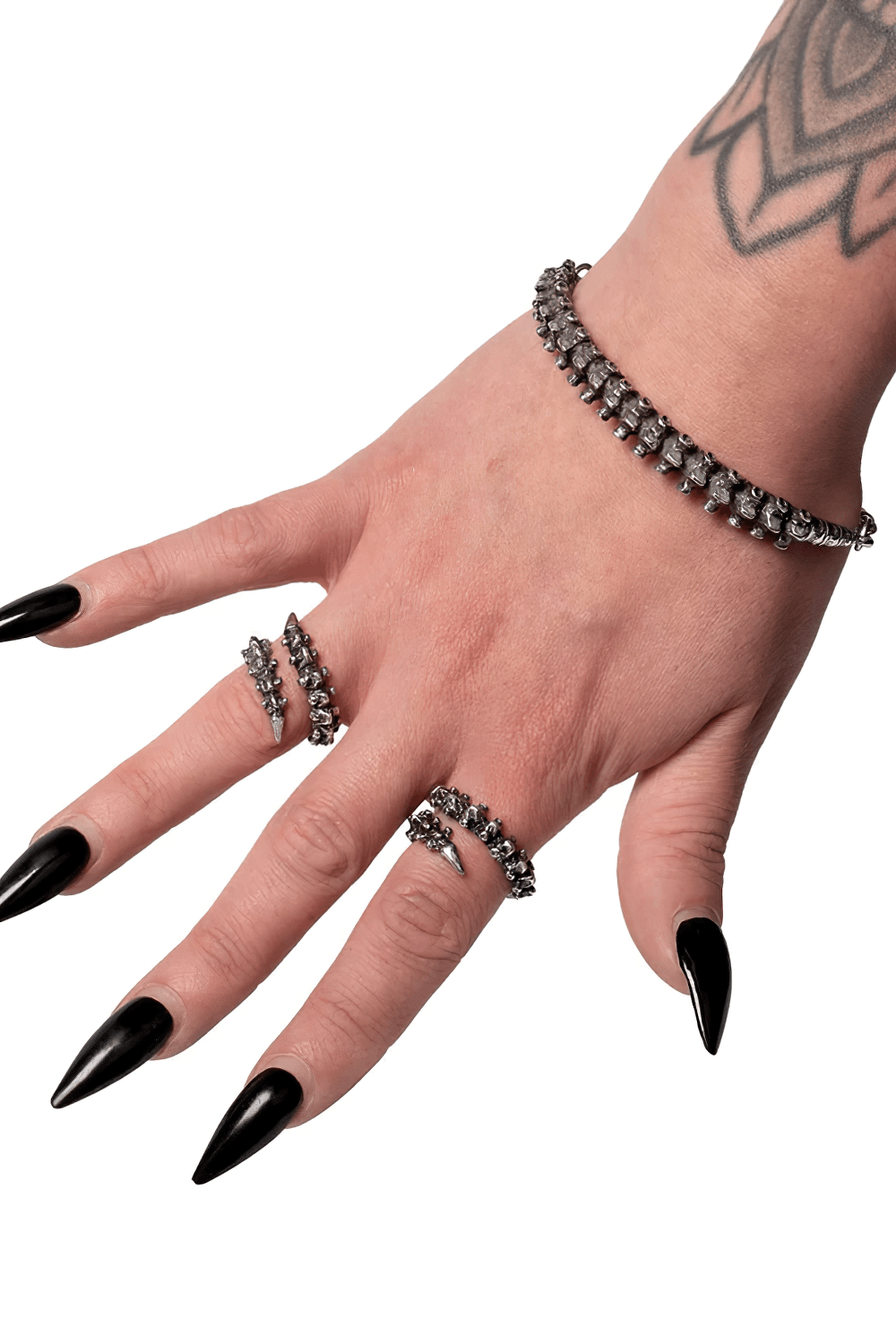 Dark Gothic Bracelet with Vertebrae Pewter Detail showcased on a hand with long black nails and rings.