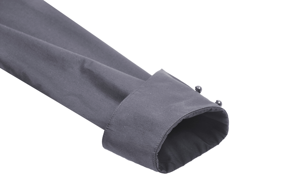 Close-up of the sleeve cuff of a dark gothic ruffle blouse featuring unique button details.