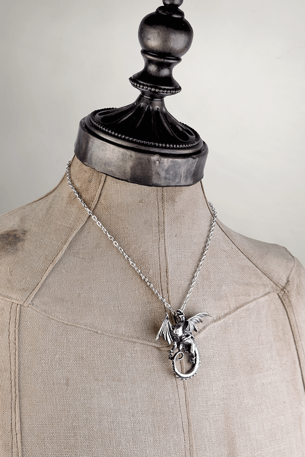 Dark Gothic Dragon Pendant on display, showcasing detailed serpentine wings and fine pewter craftsmanship.