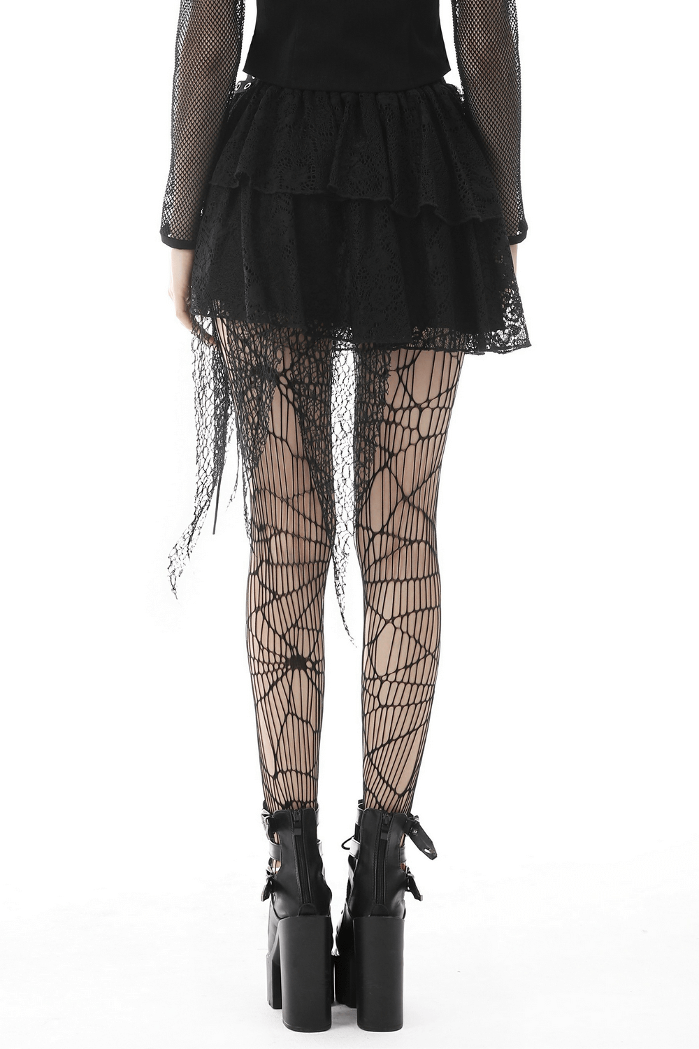Back view of dark gothic mini skirt with layered lace and edgy mesh overlay, paired with spider-web tights and chunky boots.