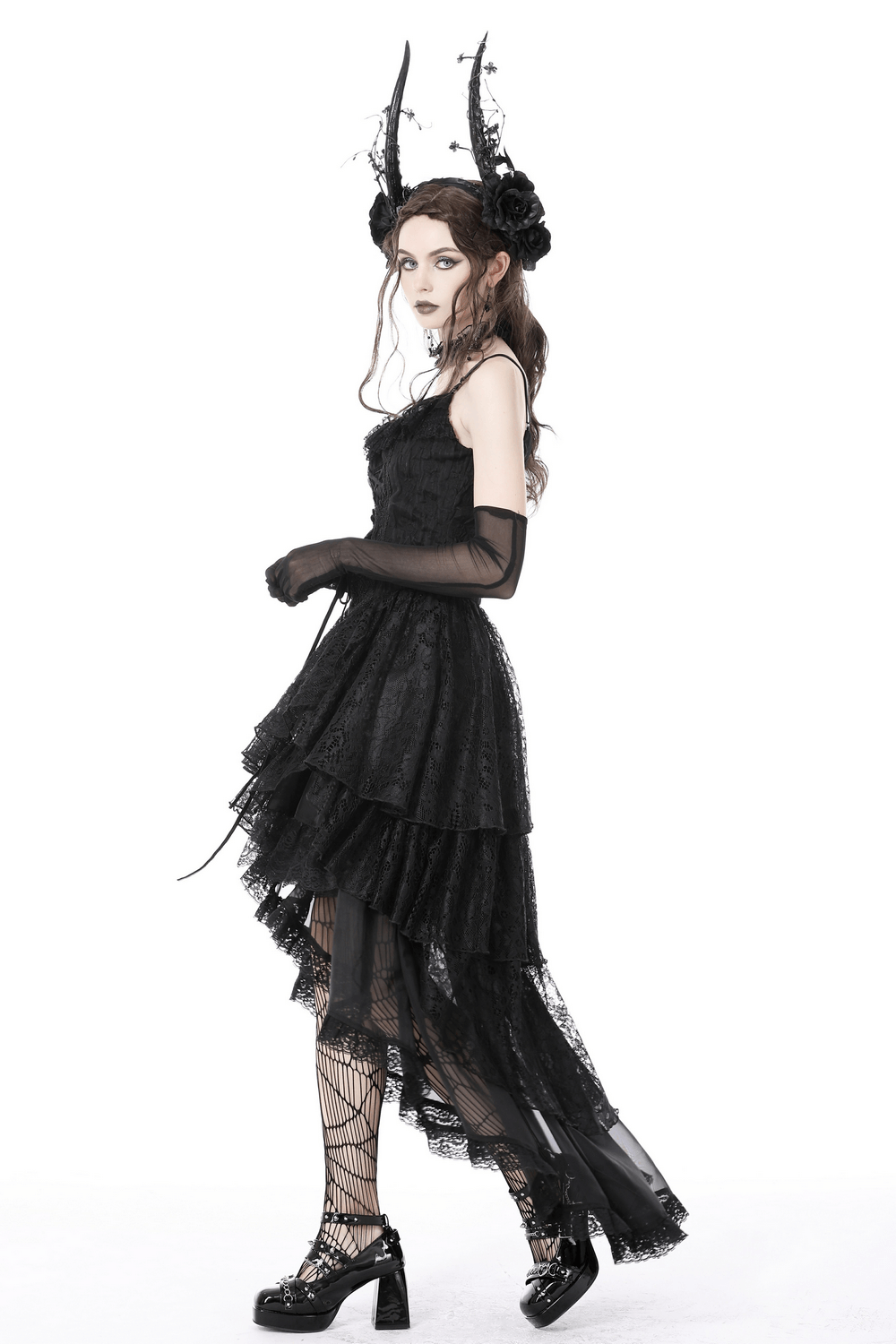 Dark gothic model in high-low black chiffon skirt with lace trim and dramatic horned headpiece.