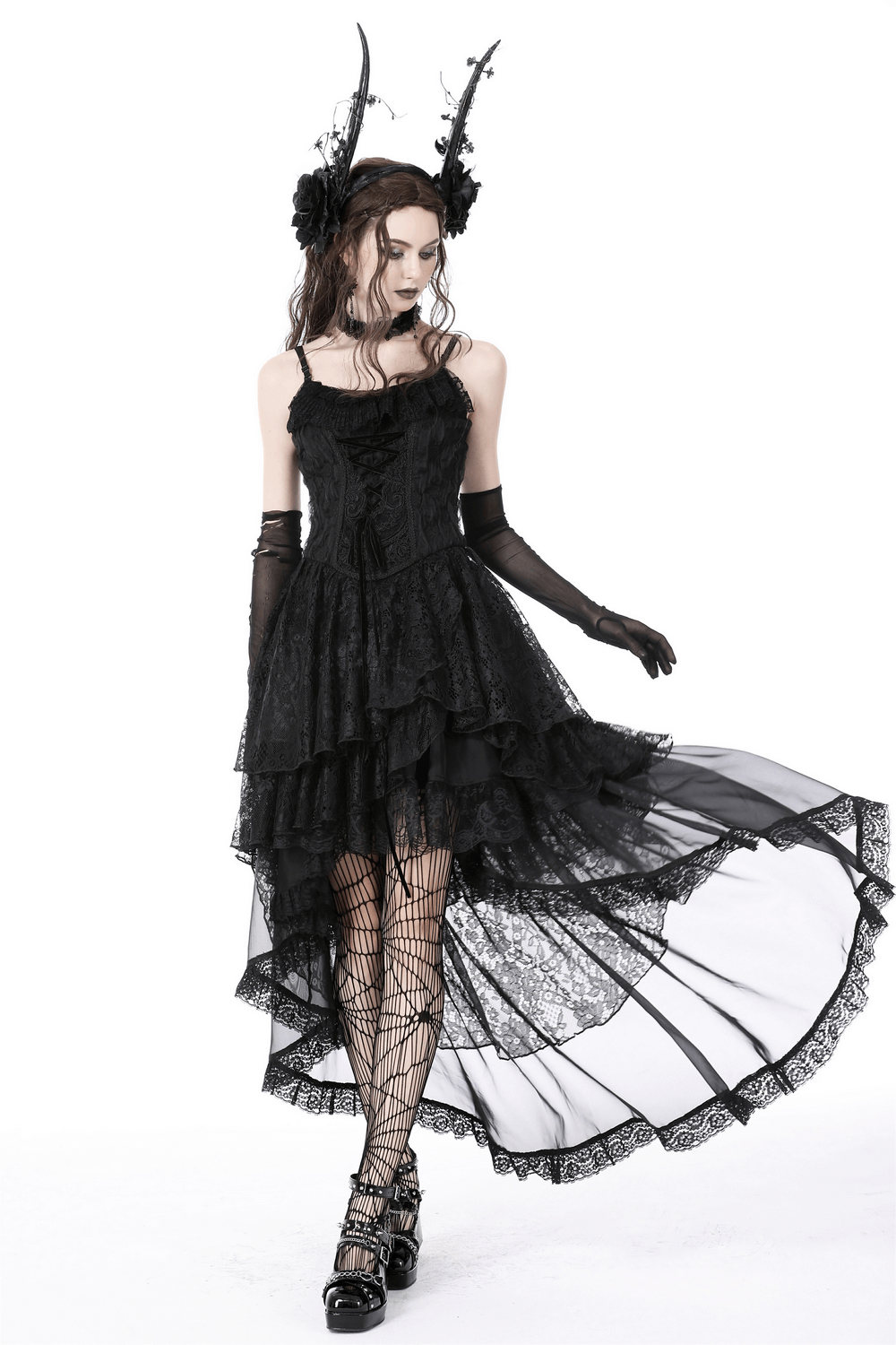 Model wearing a dark gothic high-low chiffon skirt with lace trim, showcasing dramatic design and elegant flow.