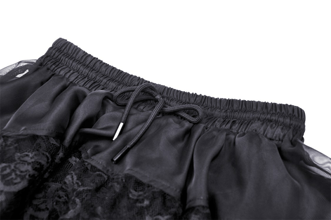 Close-up of dark gothic lace trimmed waistband on a high-low chiffon skirt, showcasing stylish drawstring detail.