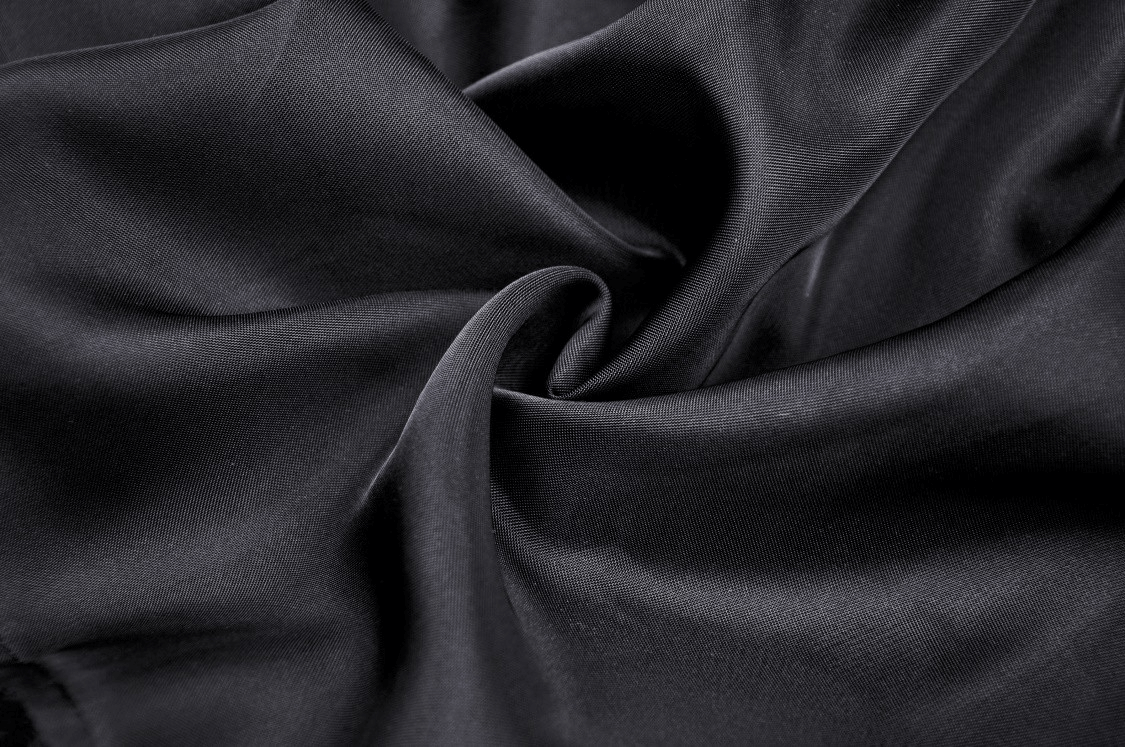 Close-up of soft black chiffon fabric showcasing its elegant, smooth texture ideal for gothic fashion.