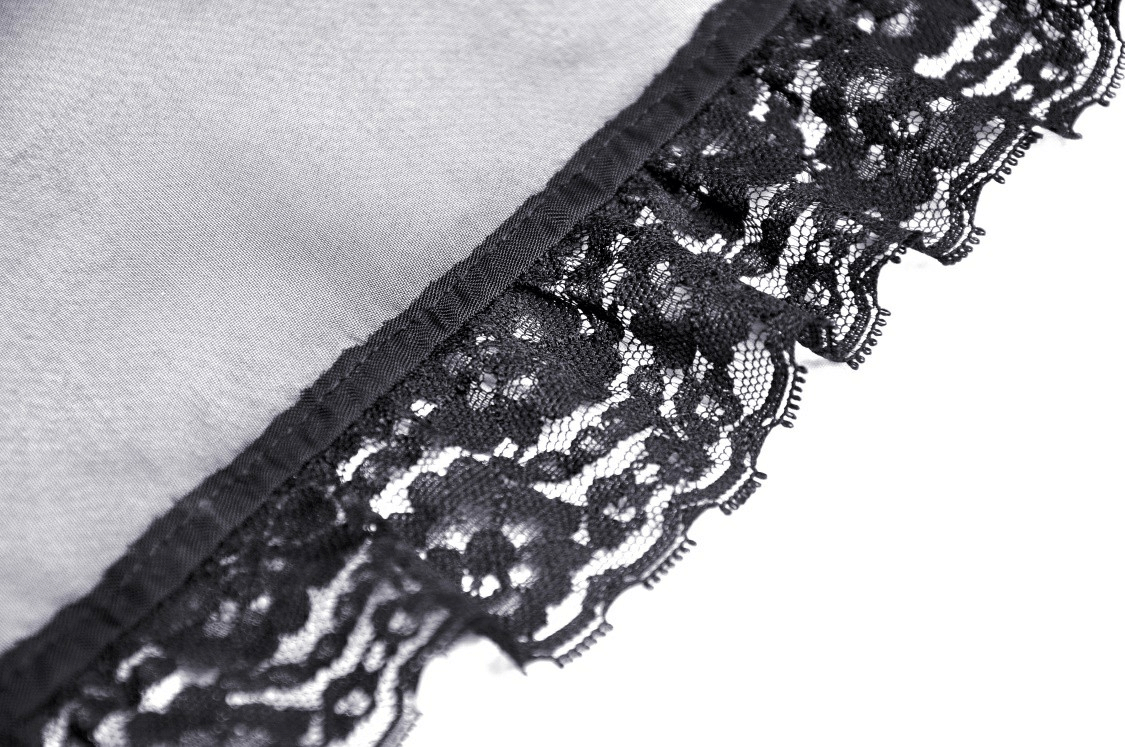Close-up of black lace trim on a flowy chiffon skirt, showcasing intricate gothic detailing.