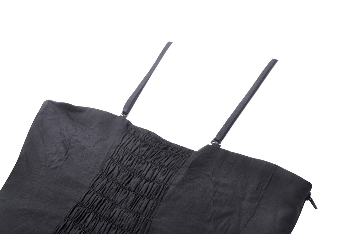 Close-up of a black lace-up bustier corset top featuring delicate ribbon straps and intricate smocking.