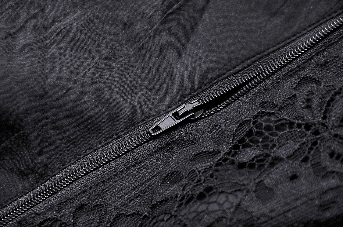 Close-up of a black lace zipper on a dark gothic corset showing intricate lace trim details.