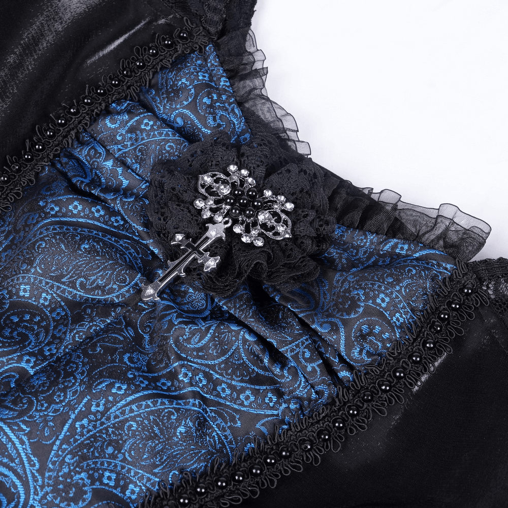 Gothic lace dress close-up with skull patterns and cross pendant detailing in dark blue and black satin.