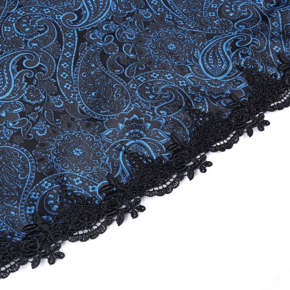 Close-up of dark blue and black lace fabric with skull pattern from a Gothic dress, featuring intricate lace details.