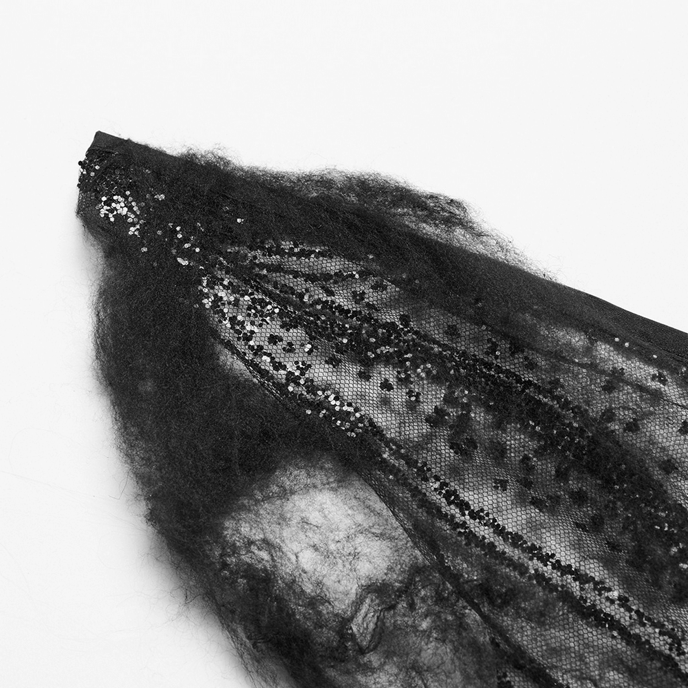 Close-up of dark gothic butterfly wing detail featuring shimmering mesh and textured cotton for cosplay costumes.