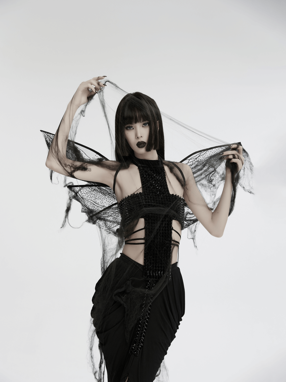 Dark gothic butterfly wings on a model with a mysterious look, showcasing elegant mesh and adjustable straps.
