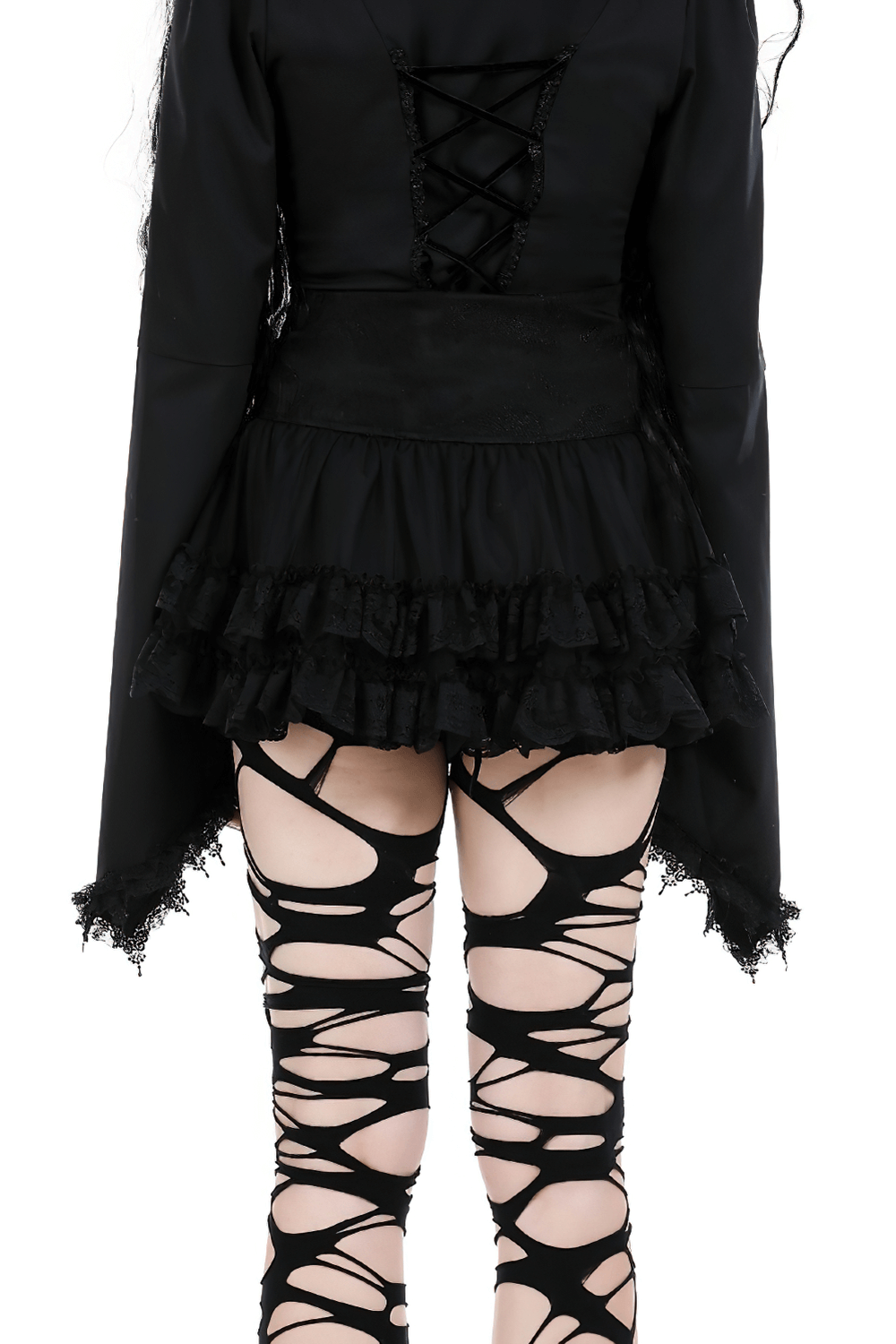 Back view of a black gothic outfit featuring lace-up top and ripped leggings, showcasing edgy punk style.