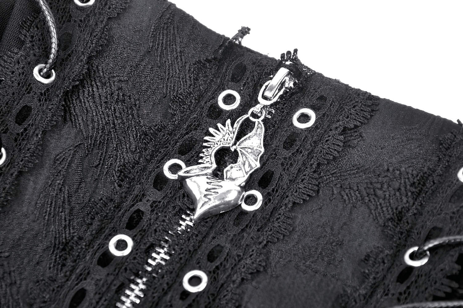 Close-up of dark gothic mini skirt showcasing lace trim and unique cross zipper detail.