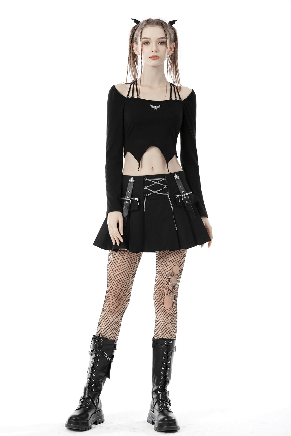 Edgy gothic outfit featuring a black crop top and skirt with fishnet stockings and combat boots, perfect for punk style.