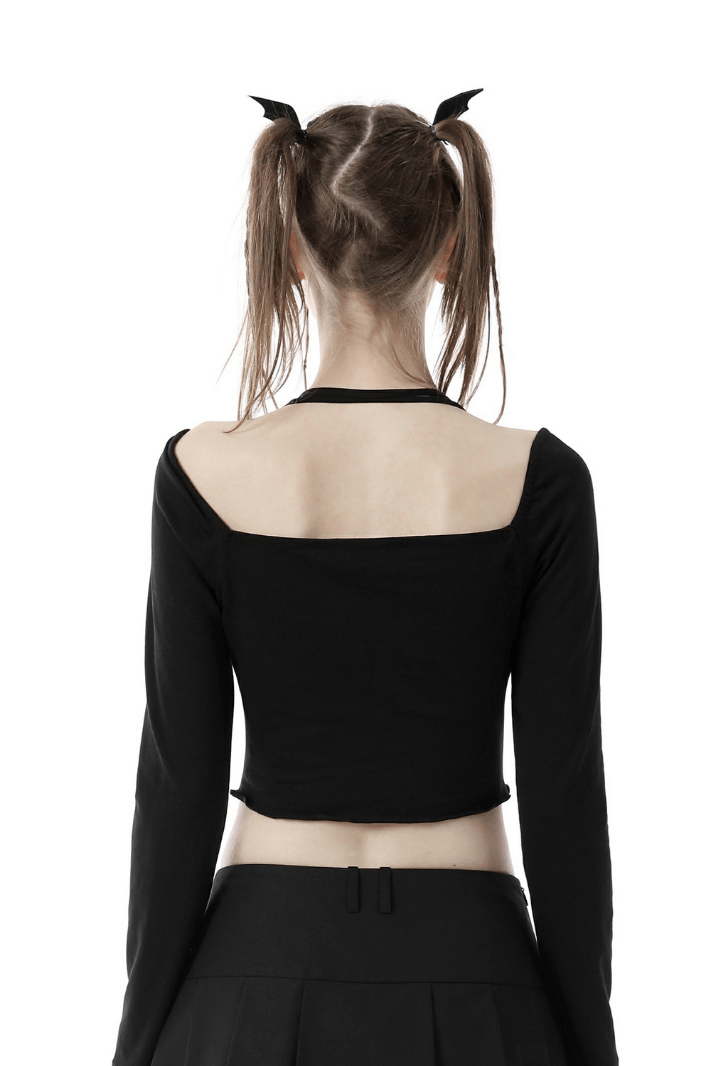 Back view of a black gothic long-sleeve halter top with a multi-rope neckline, styled with playful pigtails.