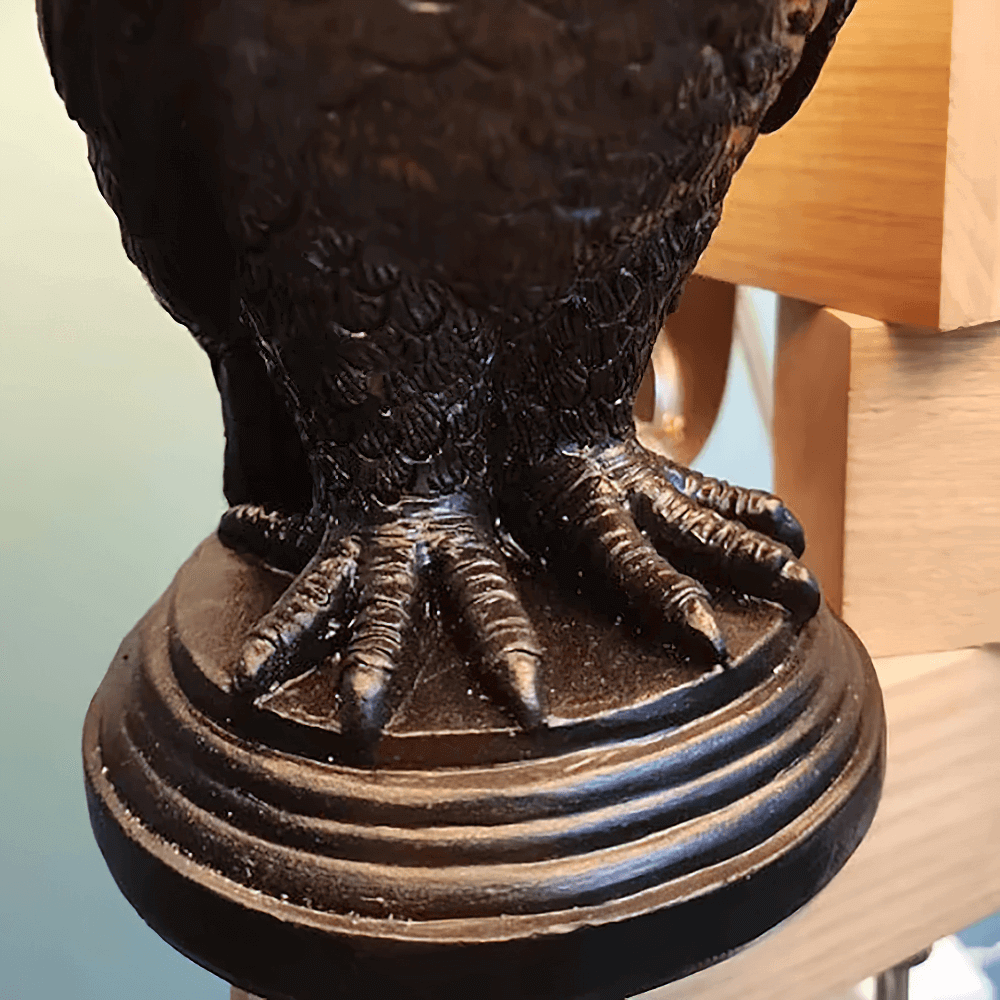 Close-up of dark gothic owl candle holder's detailed resin feet, adding eerie charm to gothic decor.