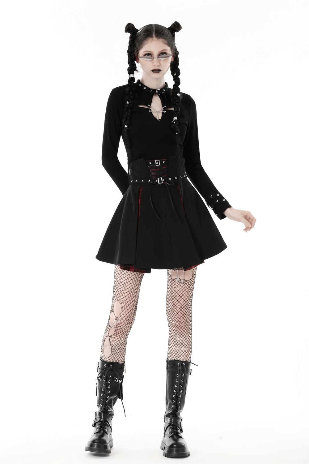 Dark gothic punk look featuring a black cutout top, skirt, fishnet tights, and combat boots, perfect for edgy style.