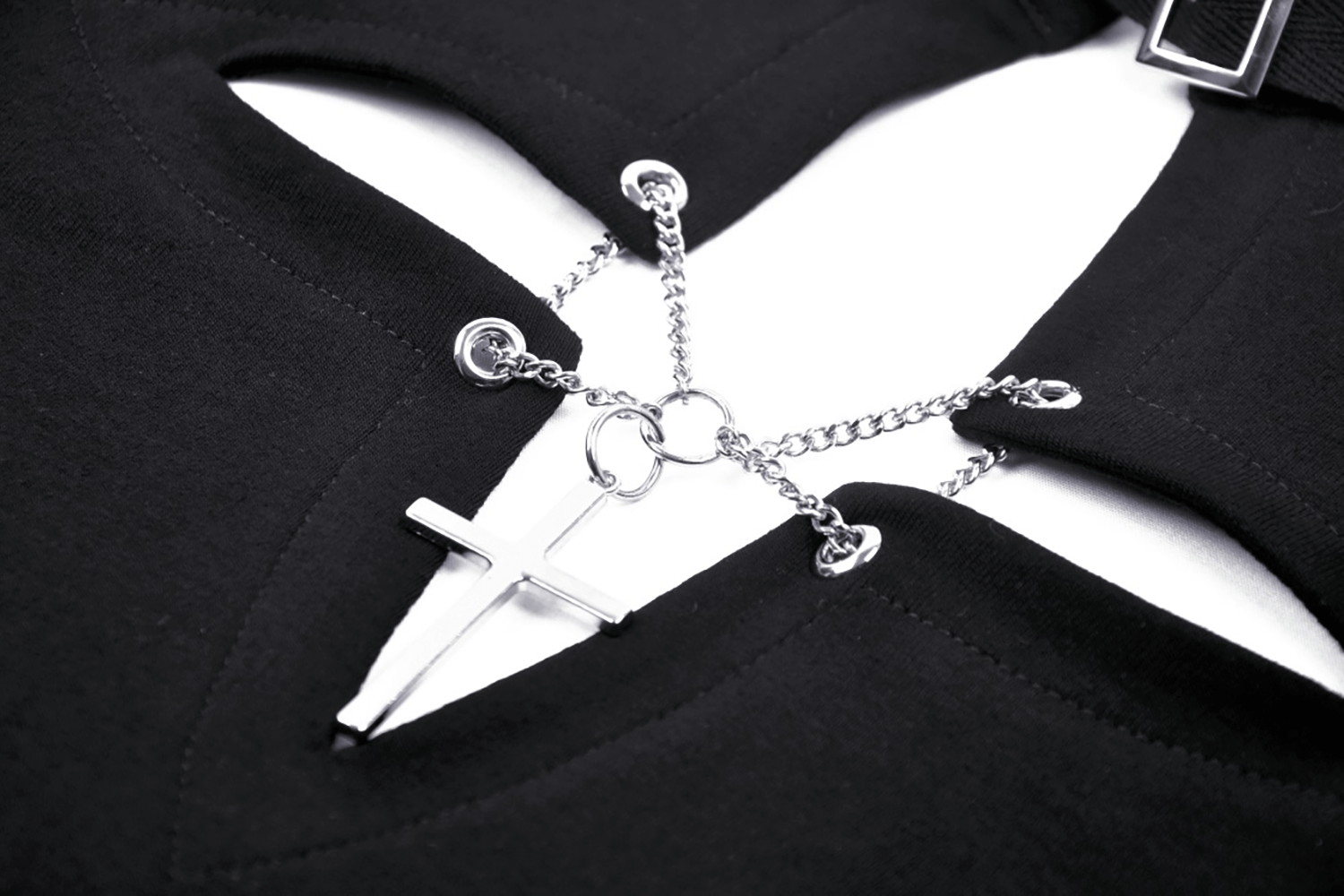 Close-up of dark gothic punk crop top with cutout cross design and edgy o-ring choker detail.