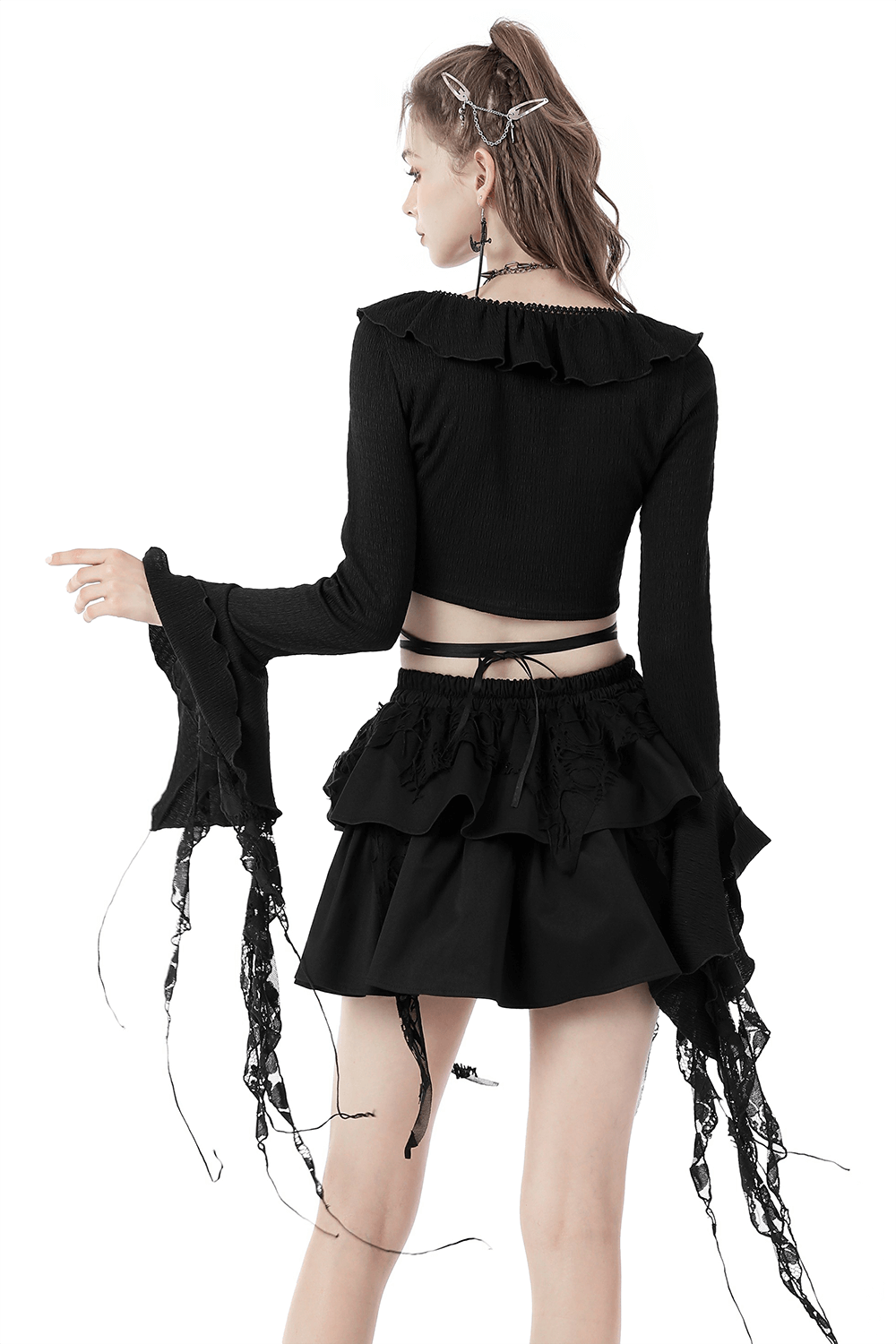 Back view of black Gothic crop top with ruffle neck and ripped sleeves, styled with a matching ruffled skirt.