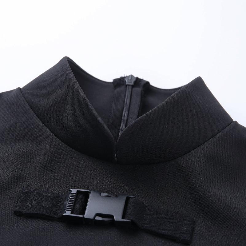 Close-up of gothic black dress with turtleneck and shoulder belt detail for European sale.