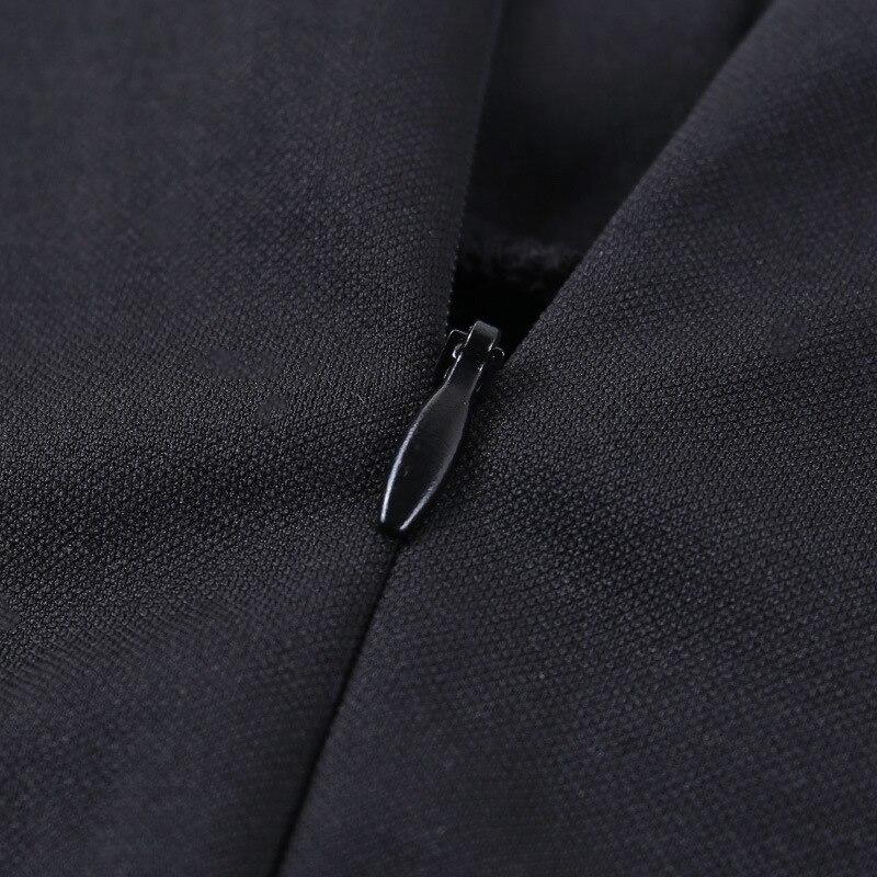 Close-up of black zipper on gothic long sleeve dress with lantern sleeves and turtleneck neckline.