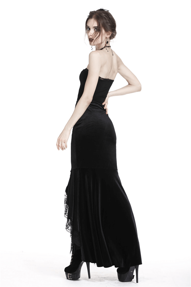 Woman wearing a dark gothic velvet fishtail skirt with lace hem, showcasing a dramatic silhouette.