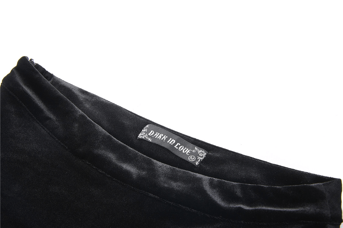 Close-up of dark velvet fabric with a label for Dark in Love, showcasing luxurious texture for gothic fashion.