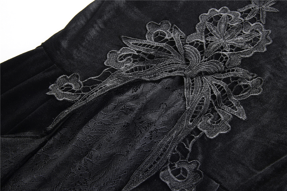 Detail view of black velvet skirt featuring intricate lace and floral embroidery for a gothic style.