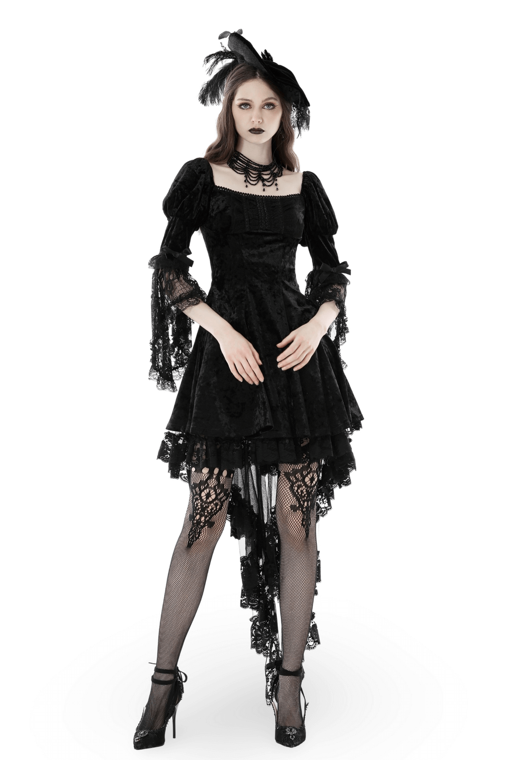 Woman in a dark gothic velvet mini dress with lace sleeves and a stylish hat, showcasing gothic elegance.