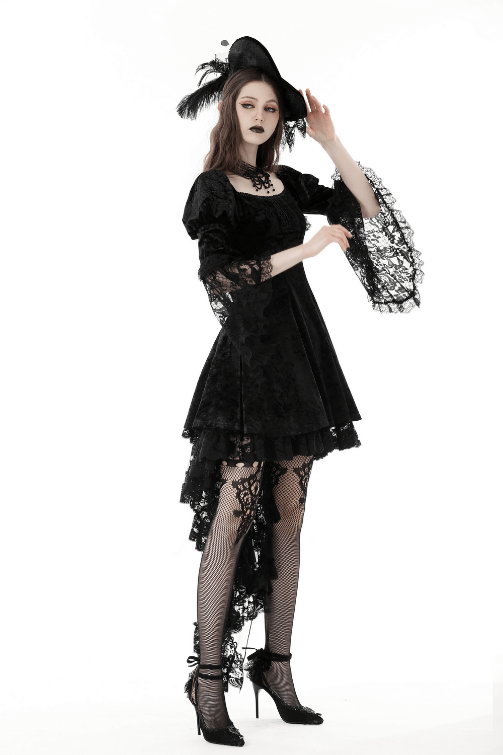 Gothic velvet mini dress with lace sleeves and a dramatic hat, perfect for a stylish evening out.