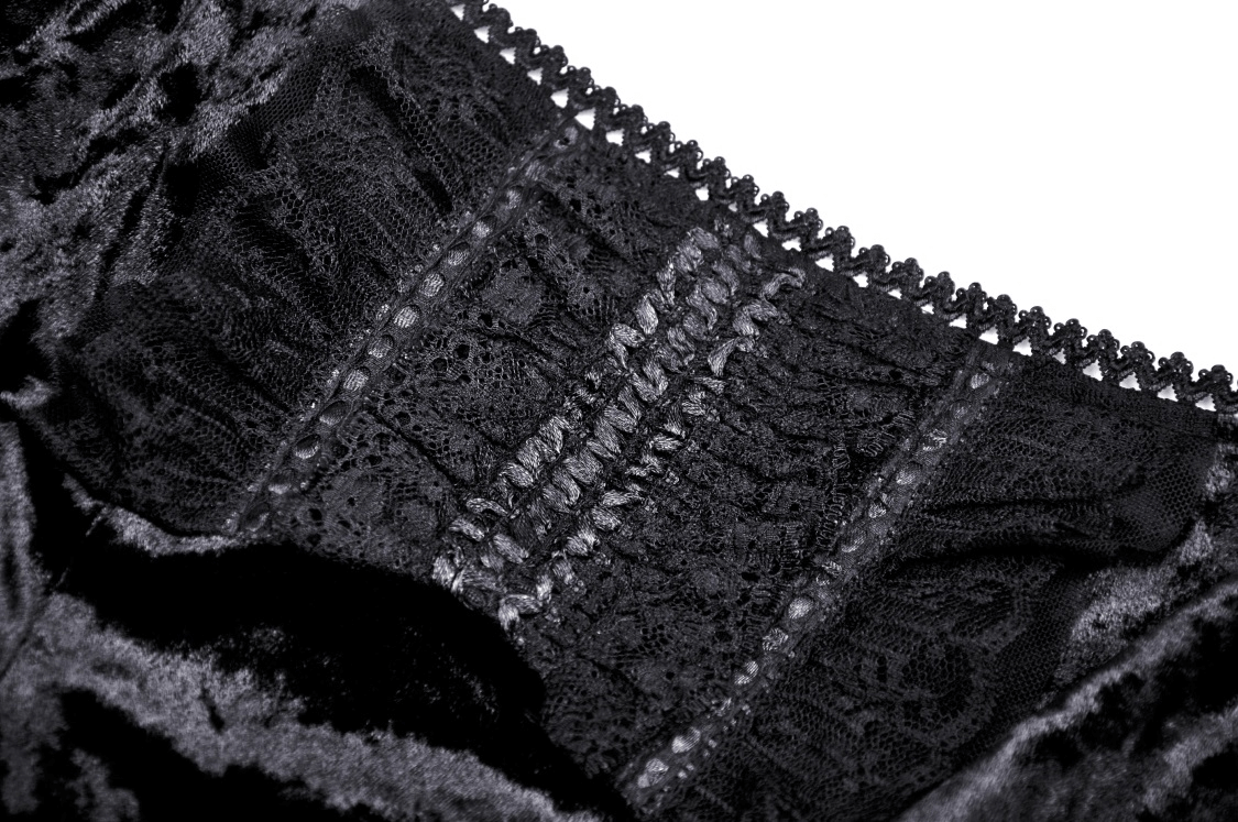 Close-up of dark gothic velvet lace fabric showcasing intricate sheer lace details and elegant design.