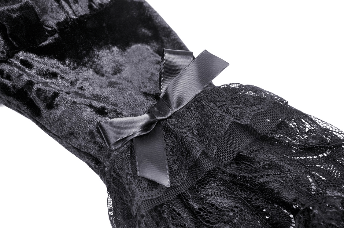 Close-up of black velvet fabric with a satin bow and sheer lace detail, perfect for a gothic mini dress.