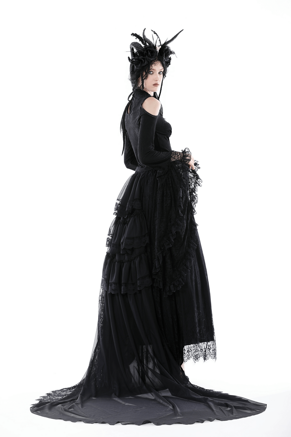 Gothic Victorian model in black off-shoulder lace top and flowing skirt, showcasing dramatic bell sleeves and elegant details.