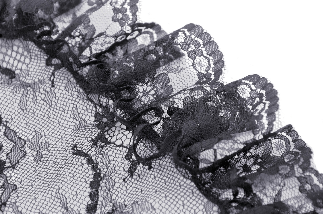 Close-up of intricate black lace detail with ruffled edges, perfect for gothic fashion and elegant designs.