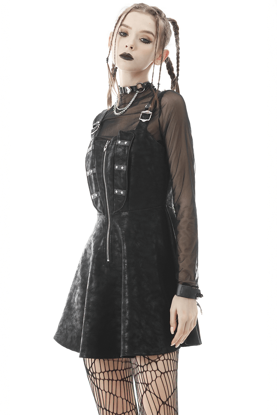 Gothic model wearing a dark mesh fishnet crop top with a black skater dress, showcasing edgy style and layers.