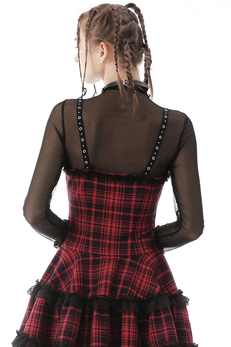 Back view of a layered red plaid dress paired with a sheer black mesh long sleeve top. Edgy goth fashion statement.