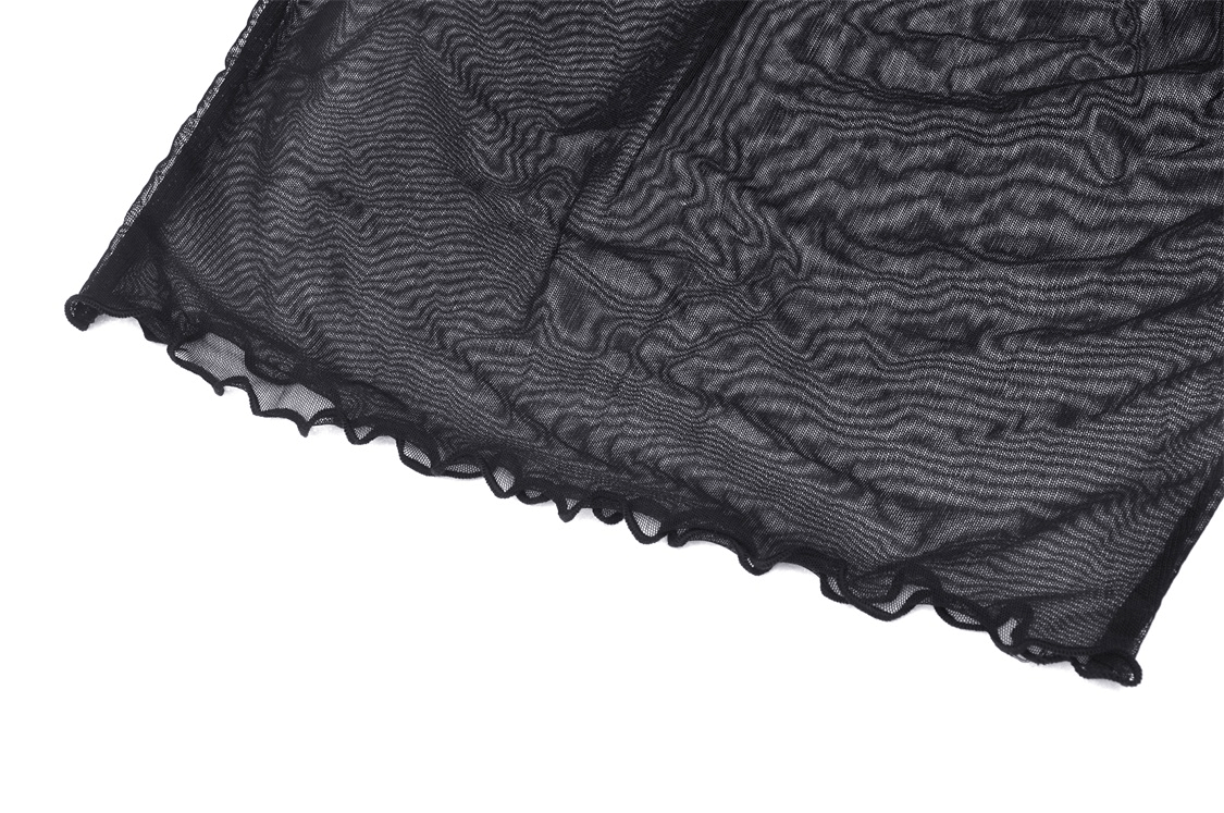 Close-up of sheer black mesh fabric with wavy texture and ruffled edges, ideal for gothic and punk layering.
