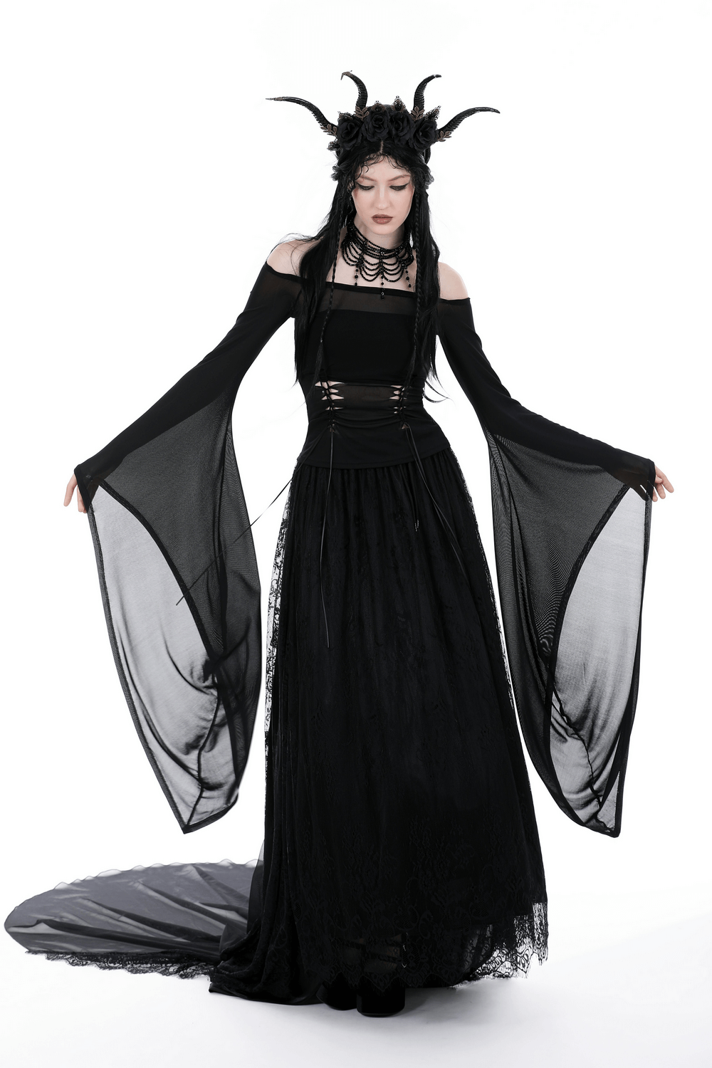 Model wearing a dark mesh off-the-shoulder top with trumpet sleeves and dramatic gothic style.