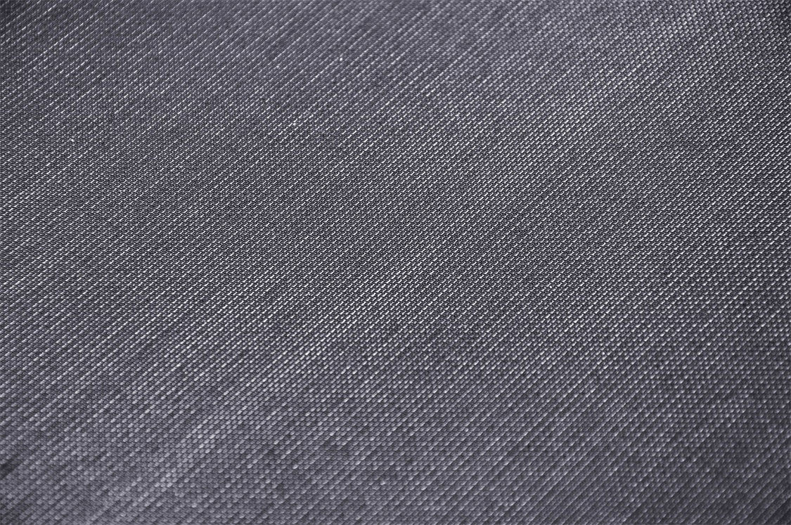 Close-up of dark mesh fabric, showcasing a textured surface perfect for gothic-inspired fashion.