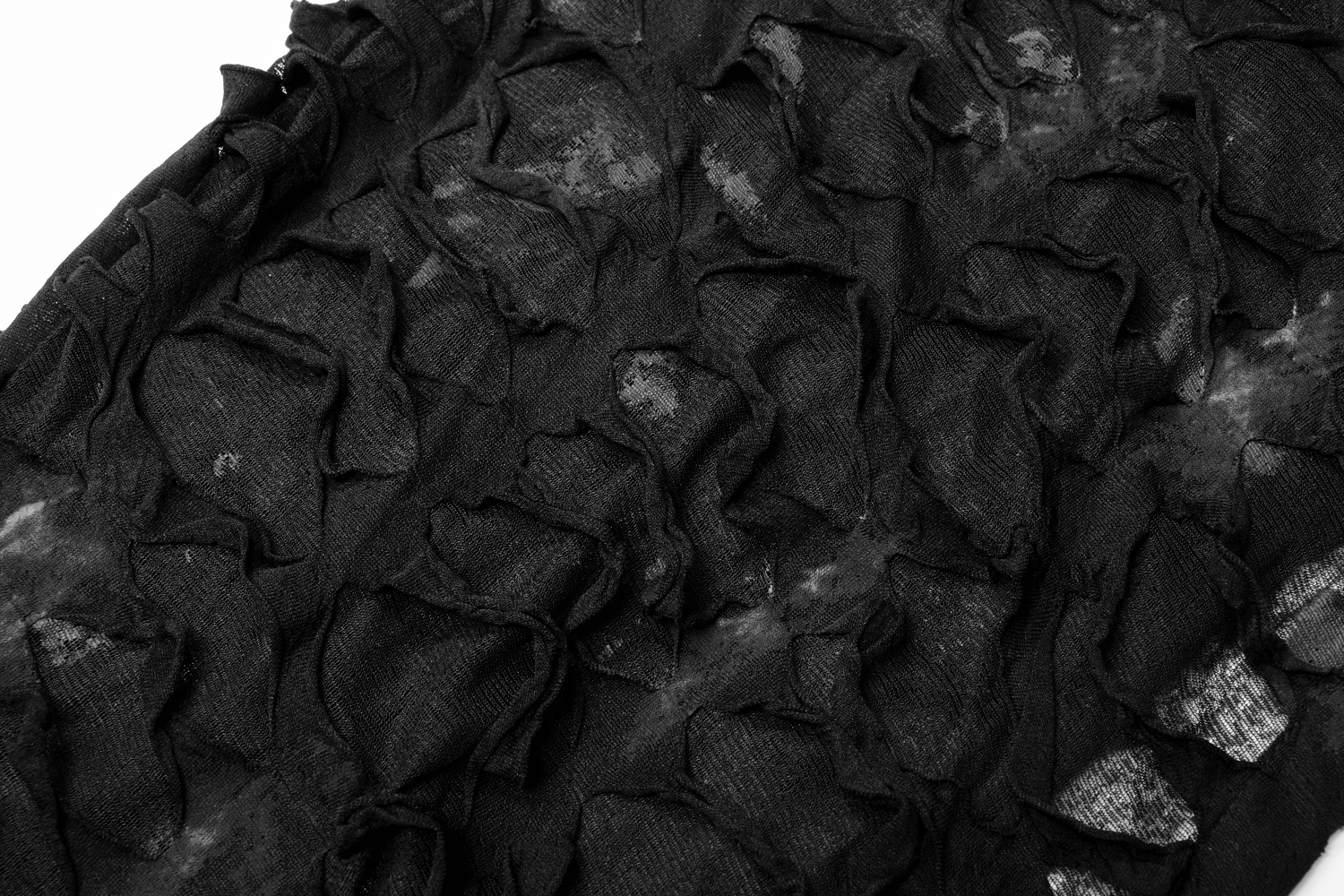 Close-up of textured black fabric with unique rips and folds, showcasing a gothic style for edgy fashion.