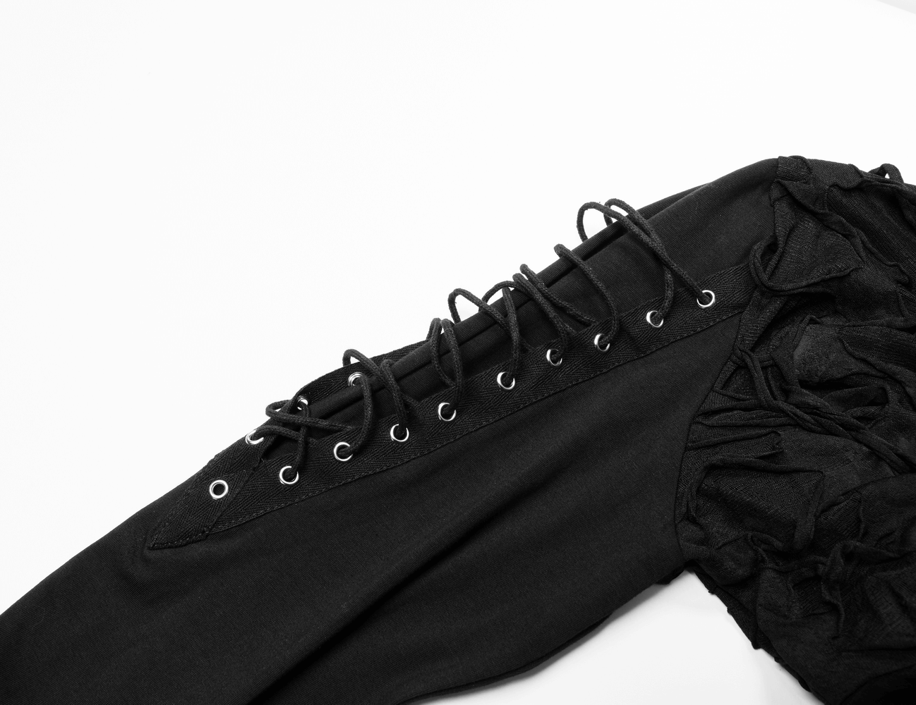 Close-up of lace-up detailing on the sleeve of a gothic black ripped hoodie with a mysterious vibe.