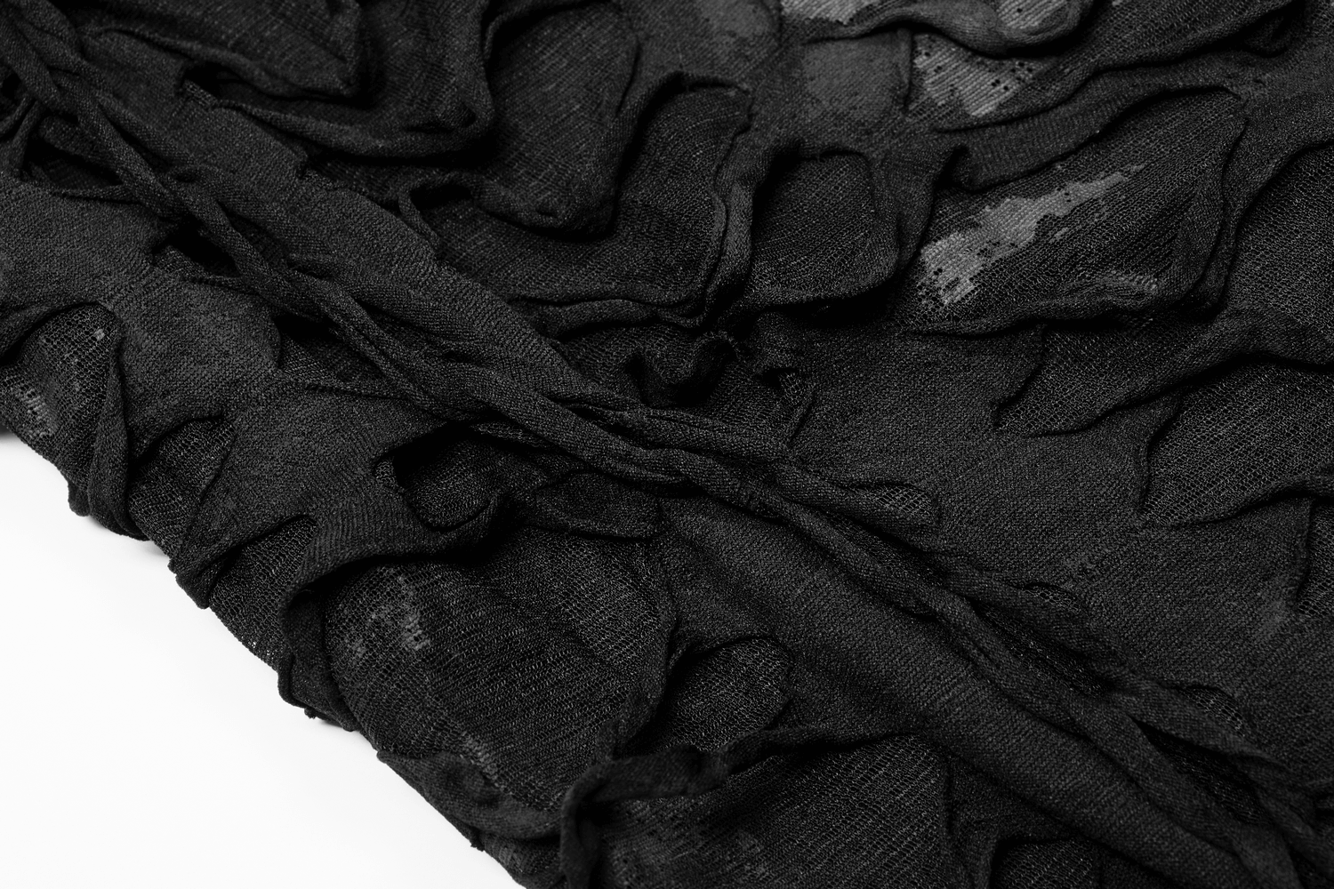 Close-up of black ripped fabric showcasing lace-up detailing and irregular holes, perfect for a gothic hoodie.